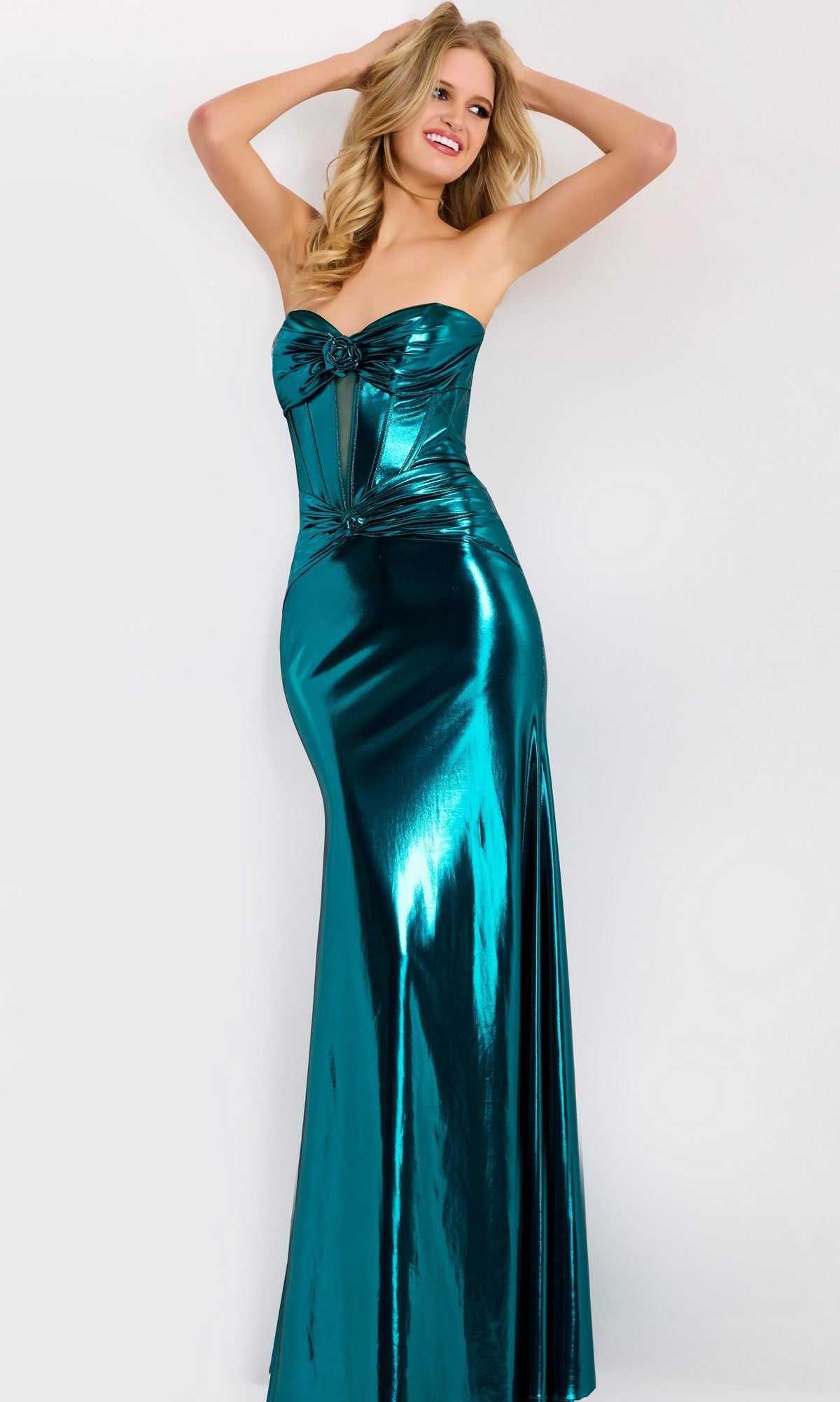 A woman poses in the Jovani 45709 long prom dress, a shiny teal metallic strapless gown with a fitted corset bodice and floor-length skirt, against a plain white background.